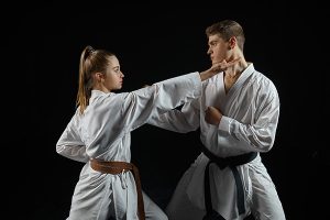 a green belt and brown belt demonstrating 2 of the 10 martial arts techniques you should know