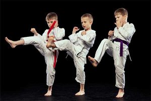 3 preschool martial artists displaying the many benefits of karate at a young age