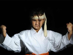 a young martial arts student showcasing the physical attributes of an indomitable spirit