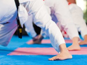 a martial arts class preparing for the day by stretching